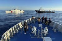 Chinese coast guard and suspected Chinese militia ship block a Philippine coast guard ship.