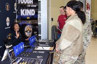 A police officer with the Montgomery Police Department speaks with an airman from the 117th Air Refueling Wing at the 117th ARW military resource and career fair at Sumpter Smith Joint National Guard Base, Alabama.