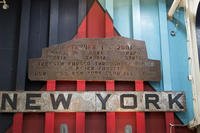 A piece of rusted steel from the World Trade Center, inscribed in remembrance of those killed, hangs over the vehicle ramp on the USS New York.
