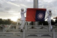 Two soldiers fold the national flag during the daily flag ceremony in Liberty Square of Chiang Kai-shek Memorial Hall in Taipei