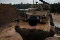An Israeli mobile howitzer gets into position near the border with Lebanon in northern Israel