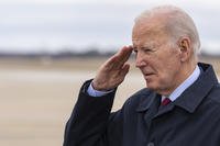 President Joe Biden salutes as he steps off Air Force One