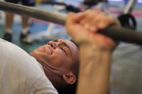 Navy sailor bench presses weights