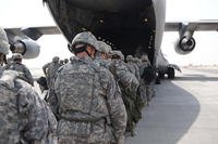 Soldiers from the 13th Sustainment Command Expeditionary march onto a C-17 Globemaster III at an undisclosed location in the Middle East.