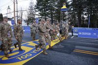 Members of the United States military cross the starting line as they participate in the Boston Marathon