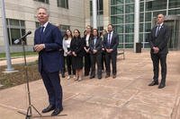 U.S. Attorney for Colorado Cole Finegan, left, speaks outside Denver federal court