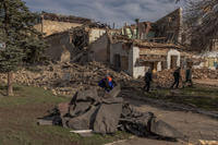 Communal workers clear rubble following an overnight missile strike on a House of Culture in the town of Druzhkivka, Donetsk region, on April 1, 2024, amid the Russian invasion of Ukraine.