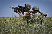 Ukrainian servicemen search a target with a US Stinger air defence missile launcher