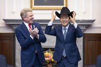 Taiwan President Lai Ching-te, right, puts on a cowboy hat given by Rep. Michael McCaul.