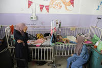 Amira Al-Jojo, left, stands beside her 10-month-old son, Yousef Al-Jojo.