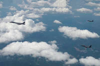U.S. Air Force B-1B bomber, left, and South Korean fighter jets F-15K fly over the Korean Peninsula