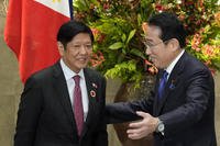 Japan's Prime Minister Fumio Kishida, right, greets Philippines' President Ferdinand Marcos Jr.