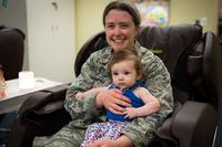 Chaplain holds her child at a lactation room at Nellis Air Force Base