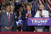 U.S. Rep. Mike Kelly, right, speaks as U.S. Rep. Dan Meuser, left, the Hon. Fred Keller, second from left, and Republican presidential candidate and former President Donald Trump look on during a Trump campaign rally in Erie, Pa.