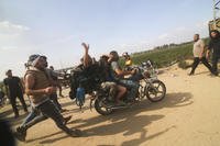 Palestinians transport a captured Israeli civilian, Noa Argamani, on a motorcycle from southern Israel