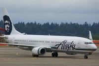 Alaska Airlines jet sits on a runway