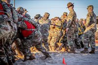 Newly arrived trainees compete in tug of war at Fort Moore