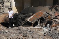 A man walks on rubble at the site of an Israeli airstrike in Beirut's southern suburbs.