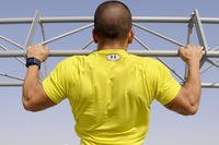 Air Force Senior Airman Brandon Stout, 380th Expeditionary Civil Engineer Squadron, does pull-ups during a workout at an undisclosed location in Southwest Asia.