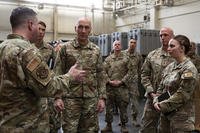 U.S. Air Force airmen from the 374th Logistics Readiness Squadron brief Air Force Chief of Staff Gen. David Allvin and Chief Master Sergeant of the Air Force David Flosi during a tour at Yokota Air Base, Japan.