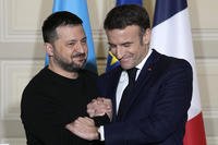 Ukrainian President Volodymyr Zelenskyy, left, and French President Emmanuel Macron shake hands