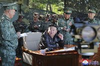 North Korean leader Kim Jong Un, center, visits a special operation forces unit