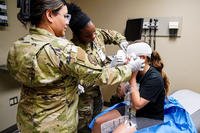 Airmen apply a dressing to a “casualty” during the Ready Eagle II exercise