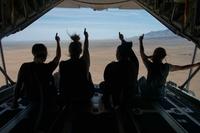 Military family members give a thumbs up while flying over Albuquerque