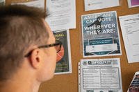 U.S. Army soldier reads a voting pamphlet at Camp Kościuszko, Poland