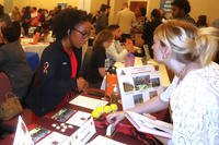 A Kimbrough Ambulatory Care Center employee provides information for individuals interested in seeking employment in the military health system at a community job fair hosted by the Fort Meade installation on Fort Meade, Maryland.