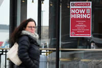 Hiring sign is displayed at a Chipotle restaurant in Schaumburg, Ill