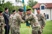 U.S. Army Col. Christopher J. Kirkpatrick receives the Joint Multinational Readiness Center colors from Brig. Gen. Steven P. Carpenter during a Change of Command Ceremony near Hohenfels, Germany.