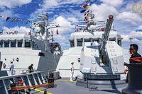 Cambodian navy crew stand on a patrol boat at the Ream Naval Base in Sihanoukville