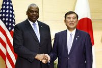 U.S. Defense Secretary Lloyd Austin, left, shakes hands with Japan's Prime Minister Shigeru Ishiba