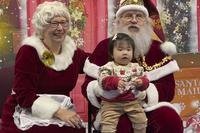 Santa and Mrs. Claus talk to a child in Yakutat, Alaska,