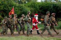 Marines and sailors from 2nd Battalion, 3rd Marine Regiment, enter the Boondocker training area at Marine Corps Base Hawaii after a 9-mile hike, Dec. 19, 2011.