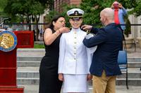 Midshipman Natalie Ke'alohilani Turner receives her shoulder boards during the George Washington University Naval Reserve Officers Training Corps (NROTC) commissioning ceremony at the Navy Memorial in Washington, D.C., May 20, 2024. The spring 2024 commissioning class consisted of 25 graduating midshipmen and enlisted Marines from George Washington University, Georgetown University, and The Catholic University of America. (Chief Mass Communication Specialist Amanda R. Gray/Navy)