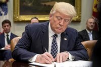President Donald Trump signs an executive order on April 25, 2017.