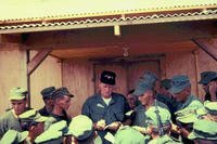 John Wayne signs autographs for Marines at the 1st Marine Division Headquarters Building in Vietnam in 1966.