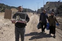 Residents of the West Bank urban refugee camp of Nur Shams evacuate their homes