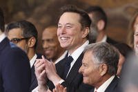 Elon Musk listens as President Donald Trump speaks