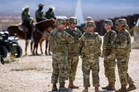 Army soldiers chat near the the U.S.-Mexico border in Sunland Park, New Mexico