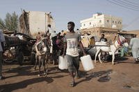 People gather to collect water in Khartoum, Sudan.