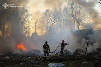 firefighters put out the fire following a Russian rocket attack in Kharkiv, Ukraine
