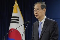 South Korean acting President Han Duck-soo speaks during a briefing at the Government Complex
