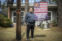 Retired U.S. Marine Stephen Watson stands outside his home.
