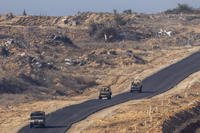 Israeli military vehicles move inside the Gaza Strip, as seen from southern Israel