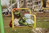 Flowers and toys left on a swing seat to commemorate victims of Russian missile attack
