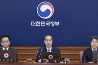 South Korean acting President Han Duck-soo, center, speaks during a Cabinet meeting at the government complex in Seoul.