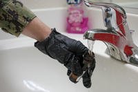 A sailor assigned to the Navy’s Water Quality Action Team (WQAT) collects a rapid-response drinking water sample at a Moanalua Terrace neighborhood residence in Honolulu.